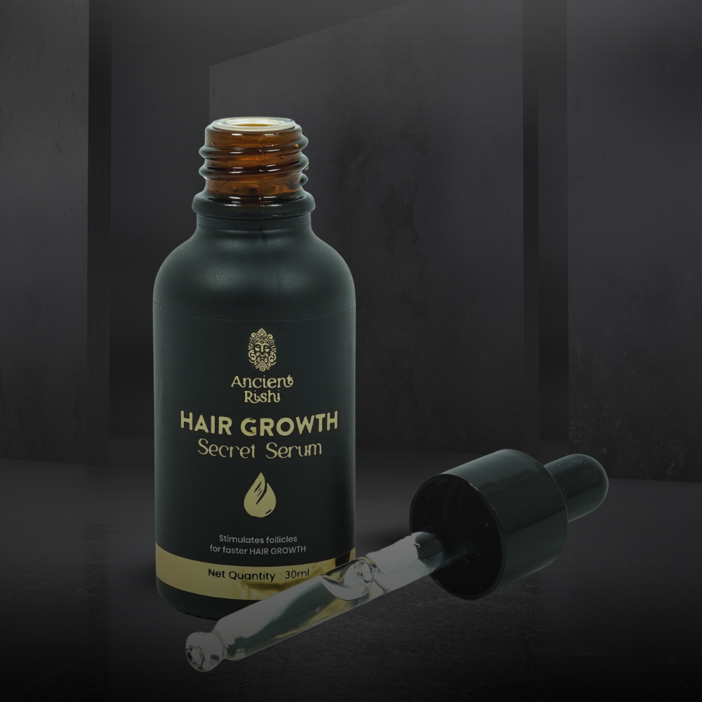 Hair growth serum bottle with dropper on a dark background